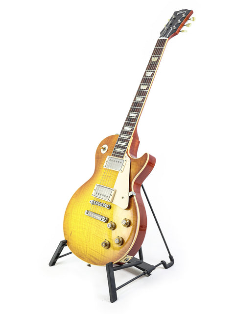 2009 Gibson Les Paul '59 Reissue guitar elegantly positioned on a stand, highlighting its iconic shape and finish.