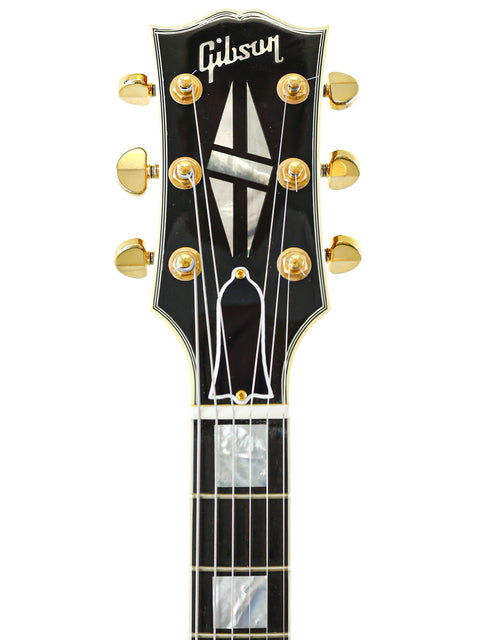 2011 Gibson Custom Shop ES-355 in black, highlighting its elegant curves and high-quality finish.