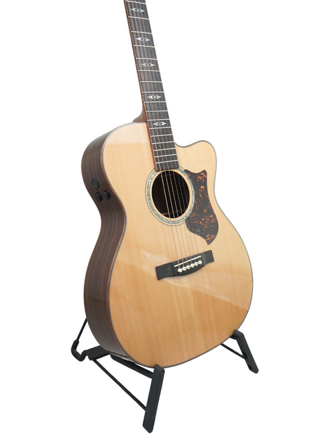 2011 Martin OMC-PA1 guitar resting on a stand, highlighting its beautiful wood finish and intricate details.