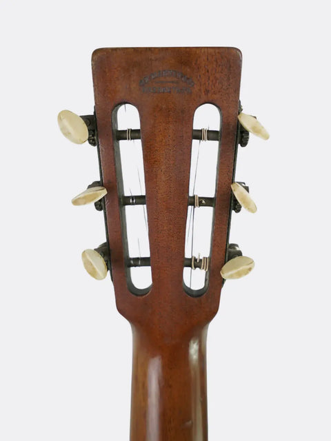 Close-up of a  Martin 2-17 headstock with tuning pegs on a white background
