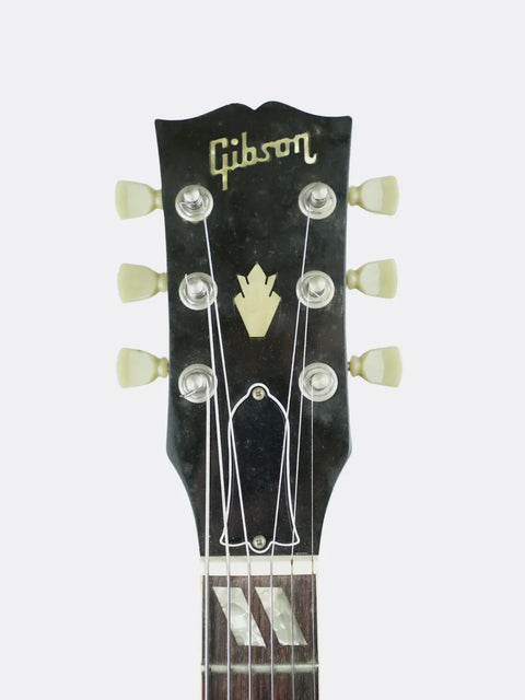 Gibson ES-175 guitar headstock with brand name on a white background