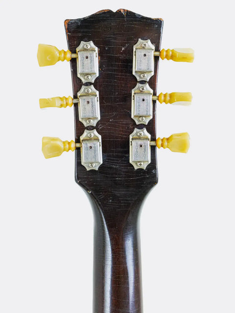 Close-up of a  Gibson ES-335 headstock with tuning pegs on a white background