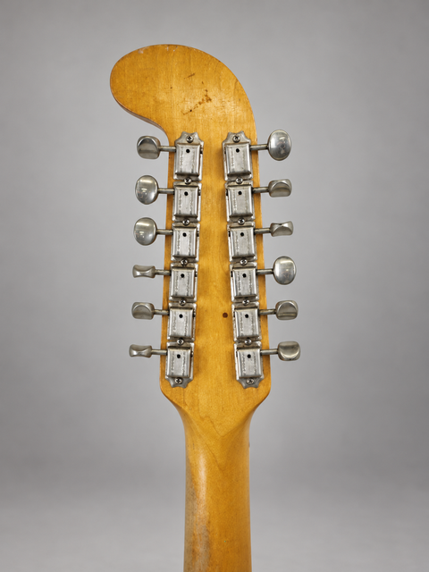 Close-up of a 1965 USA Fender Electric XII guitar head, highlighting its knobs and vintage aesthetic.