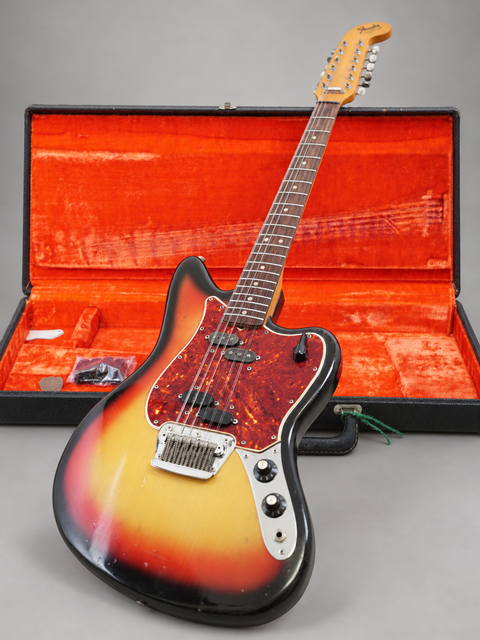A vintage 1965 Fender Electric XII guitar with a stunning sunburst finish, safely stored in its case, perfect for collectors.