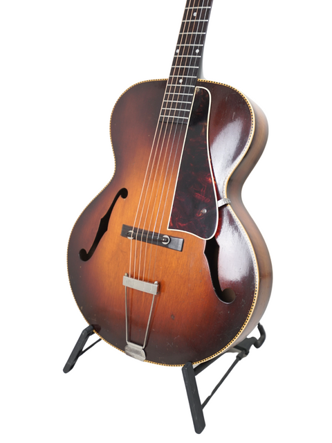 A 1951 Gibson J-45 sunburst electric guitar, highlighting its vintage appeal and craftsmanship from Kalamazoo, USA, 1938.