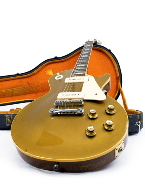 A 1968 Gibson Les Paul Standard Goldtop guitar in a case, set on a clean white background.