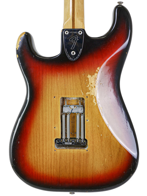 A 1974 USA Fender Stratocaster guitar featuring a striking sunburst finish, highlighting its vintage appeal.