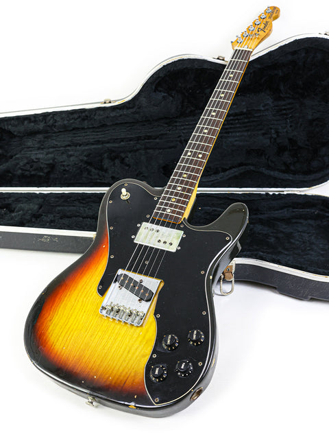 A 1977 Fender Telecaster Custom guitar in its case, set on a pristine white background.