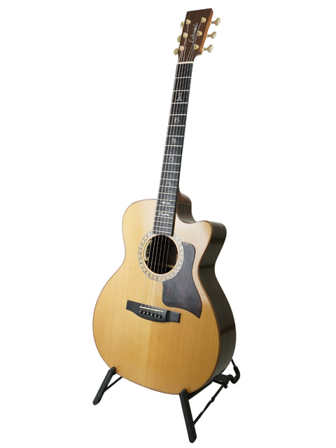 A 2004 Lakewood M-NC CP New Century II Grand Concert guitar displayed on a stand with a white backdrop.