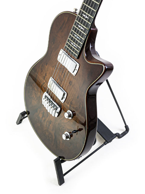 A 2007 Taylor Solid Body guitar elegantly positioned on a stand with a plain white background.