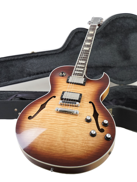 A 2009 Gibson Custom ES-137 Classic guitar alongside its protective case, highlighting its sleek body and rich finish.
