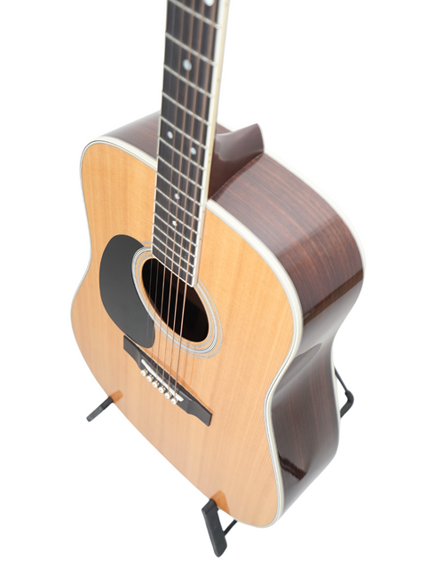A 2009 Martin D-35 Left-Handed guitar resting on a stand, set against a bright white backdrop.