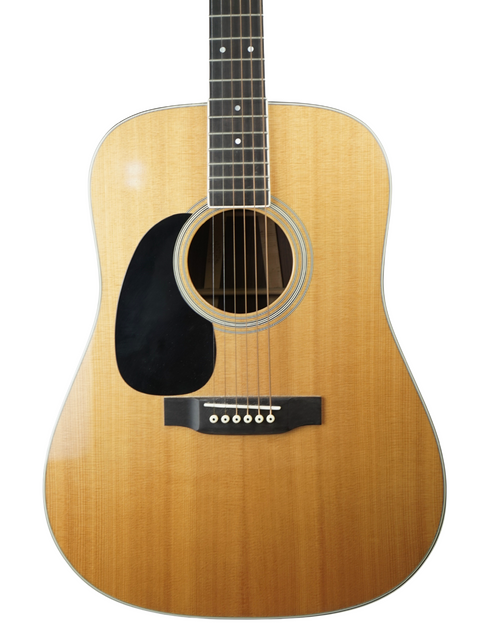 A 2009 Martin D-35 left-handed guitar set against a white backdrop, highlighting its craftsmanship and classic style.