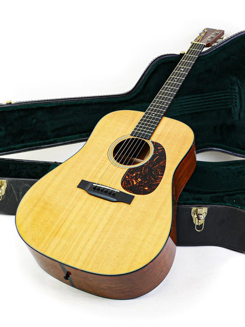 A 2012 Martin D-18 guitar is nestled in its case, highlighting the instrument's beauty and protective enclosure.