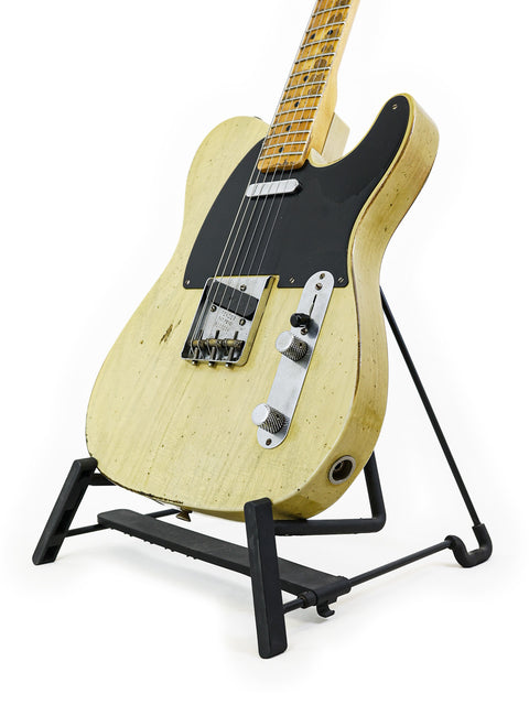 A 2020 Fender Custom Shop Nocaster guitar on a stand, set against a minimalist white backdrop.
