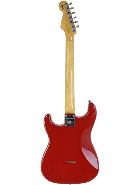 A Dakota Red Fender Custom Shop 1961 Stratocaster electric guitar with a striking white body.