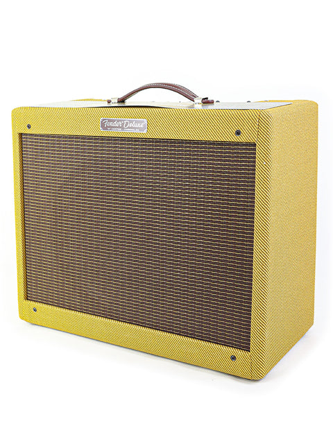 A Fender Deluxe guitar amplifier with a yellow tweed cover and brown grill cloth.
