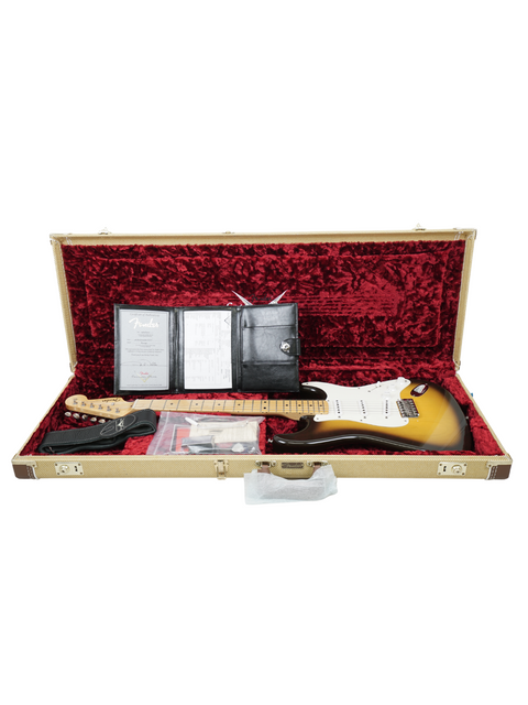 A Fender Paul Waller Masterbuilt '56 Stratocaster in a case, accompanied by various accessories and items.