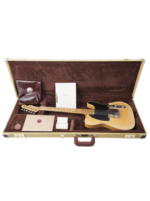 A Fender Telecaster guitar inside a case, featuring its timeless design and craftsmanship.