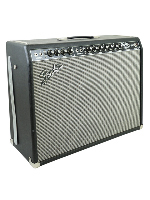 A Fender Twin Reverb guitar amplifier with black casing and control knobs on top.