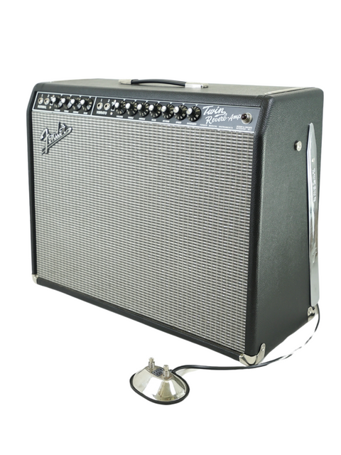 A Fender Twin Reverb guitar amplifier with black casing and control knobs on top, isolated on a white background.