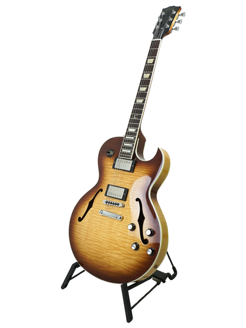  A Gibson Custom ES-137 Classic guitar from 2009 displayed on a stand, showcasing its elegant design and craftsmanship.