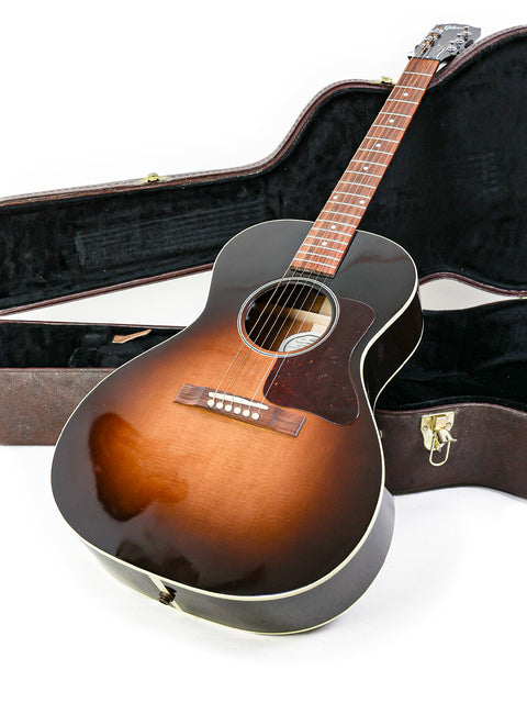 A Gibson L-00 Standard Vintage Sunburst guitar securely placed in its case, emphasizing its timeless beauty and style.