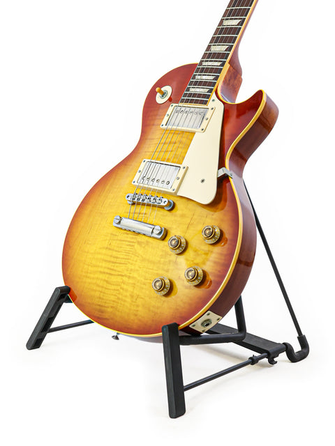  A Gibson Les Paul R9 from 2004 on a stand, set against a simple white background.