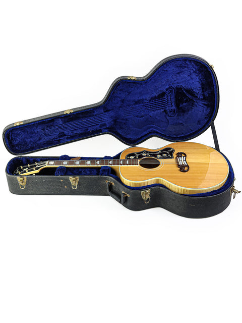 A Gibson SJ-200 guitar in a blue-covered case, showcasing its classic design from the USA, 1999.