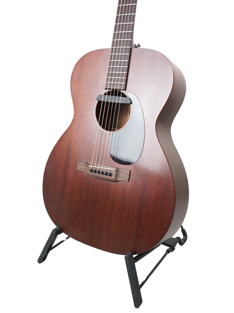 A Martin 000-15M guitar resting on a stand, featuring rich wood tones against a crisp white background.