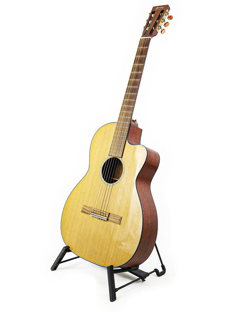 A Martin 000C-16SGCTNE guitar from 2003 resting on a stand, set against a simple white background.