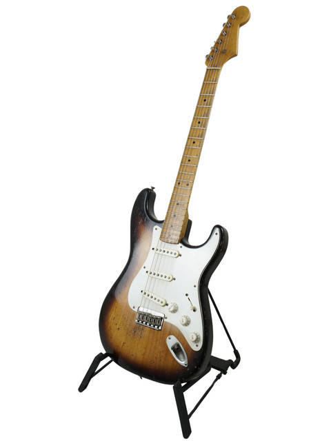 A Nacho Guitars 50s Stratocaster elegantly positioned on a stand, with a plain white background.