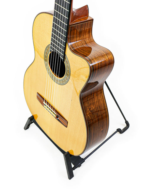 Robin Moyes Custom guitar from Australia, 2002, elegantly displayed on a stand against a clean white background.
