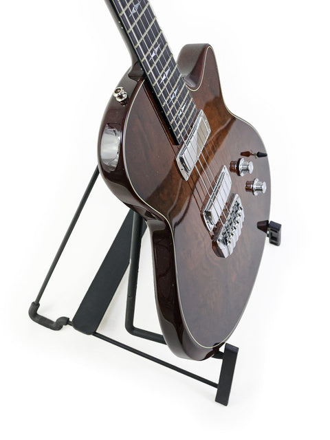 A Taylor Solid Body guitar, USA 2007 model, on a stand with a minimalist white background.