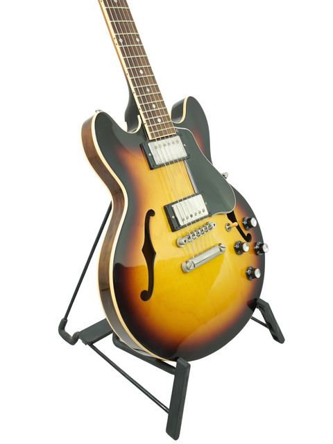 A beautiful sunburst guitar, the Gibson Custom Shop ES-339 from 2009, resting on a stand, ready for performance.