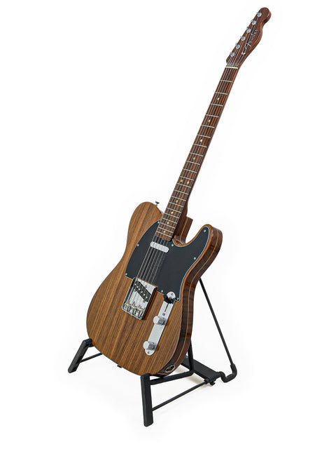A beautifully crafted Fender Telecaster guitar on a stand, featuring a rich wooden body, highlighting its limited edition design.