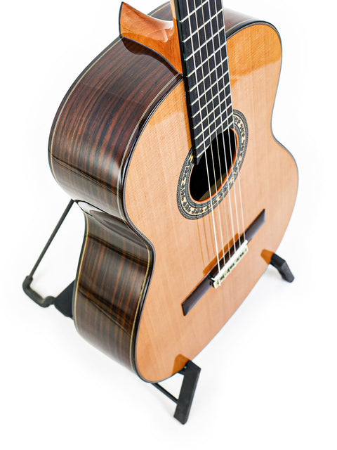 A beautifully crafted José Ramírez Estudio 3 Classical guitar from Spain, 2019, positioned on a stand for display.