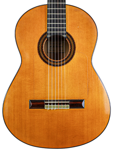 A beautifully crafted classical guitar displayed against a white backdrop, highlighting its features from M.G. Contreras, Spain, 1973.
