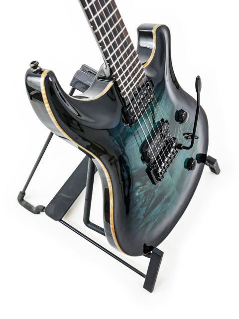 A black-bodied guitar with a blue neck, labeled Orthius Deluxe DC, showcasing its unique design from Australia, 2018.
