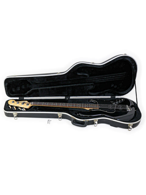  A black Fender Jazz Bass guitar from 2005 in a protective case, set on a bright white background for contrast.