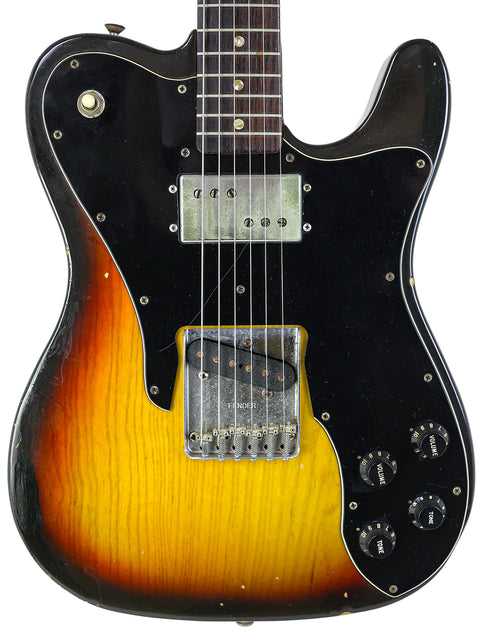A black and yellow Fender Telecaster Custom guitar with a sunburst finish, crafted in the USA in 1977.