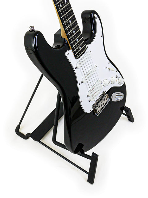 A black guitar, the Fender Strat Plus Ultra from 1993, elegantly positioned on a stand with a minimalist white backdrop.
