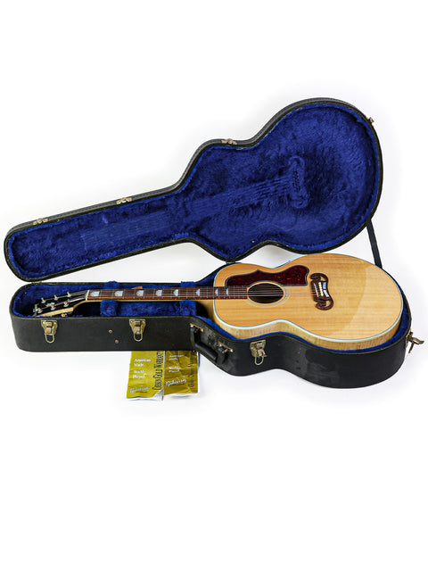 A blue case holds a Gibson SJ-150 guitar, highlighting its classic style and quality from the USA, made in 2008.