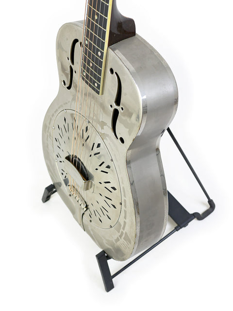A classic 1934 National Style 'O' guitar displayed on a stand with a bright white backdrop.