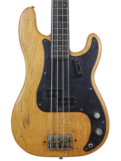 A classic 1963 Fender L-Series Precision Bass guitar featuring a wooden body and sleek black pickup, perfect for any musician.