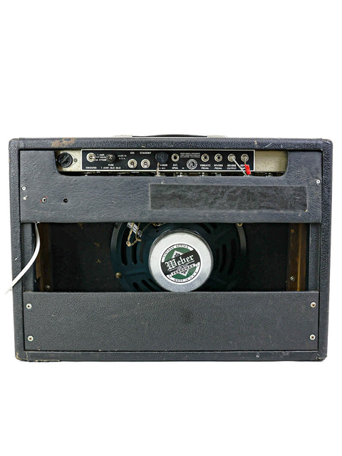 A classic 1965 Fender Deluxe Reverb amp featuring a 12" speaker in the back, perfect for vintage sound lovers.