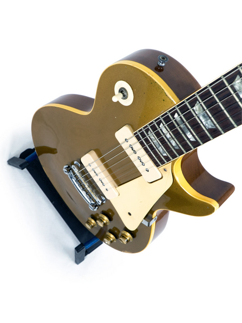 A classic 1968 Gibson Les Paul Standard Goldtop guitar, showcasing a gold finish and a contrasting black pickguard.