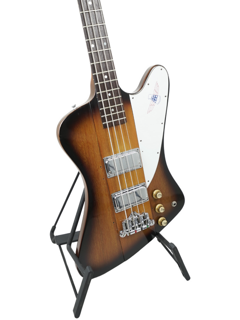 A classic 1976 Gibson Bicentennial Thunderbird IV Bass guitar sits proudly on a stand, embodying vintage musical artistry.