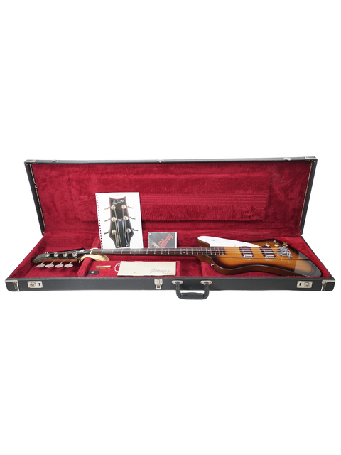 A classic 1976 Gibson Bicentennial Thunderbird IV Bass lies in its case, embodying the essence of vintage rock music.