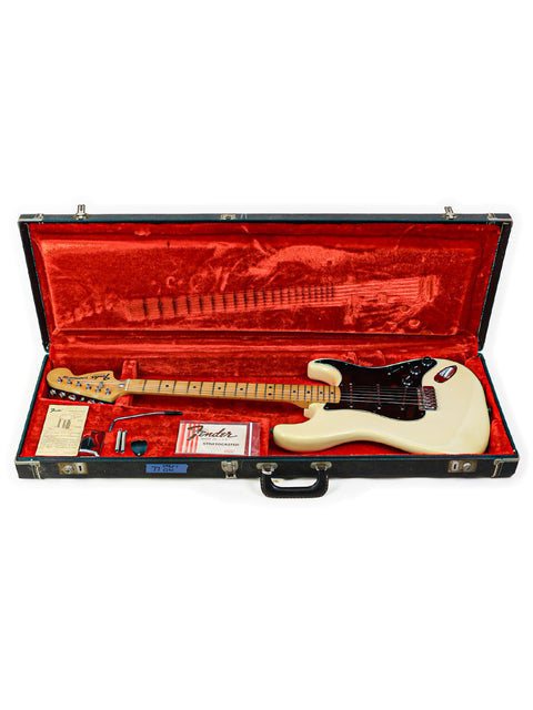 A classic 1977 white Fender Stratocaster guitar securely placed in a case, embodying timeless rock and roll heritage.